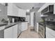 Well-lit kitchen featuring white cabinets and stainless steel appliances at 1651 Windsor Oak Ct, Kissimmee, FL 34744