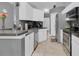 Well-lit kitchen featuring white cabinets and stainless steel appliances at 1651 Windsor Oak Ct, Kissimmee, FL 34744