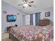 Primary bedroom featuring a ceiling fan, ample space, and adjacent tv at 1651 Windsor Oak Ct, Kissimmee, FL 34744