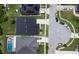 An overhead perspective of neighborhood streets, roofs, and manicured lawns on a bright, sunny day at 1723 Brassie Ct, Kissimmee, FL 34746