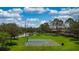 Outdoor community basketball court and scenic trees providing a welcoming and recreational space at 1723 Brassie Ct, Kissimmee, FL 34746
