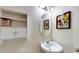 Half bathroom features storage shelf, decorative mirror and modern fixtures at 1723 Brassie Ct, Kissimmee, FL 34746