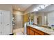 Bathroom with tiled walk-in shower, granite counters, and ample storage at 1723 Brassie Ct, Kissimmee, FL 34746