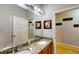 Bright bathroom featuring dual sinks, granite counters, and a large mirror at 1723 Brassie Ct, Kissimmee, FL 34746