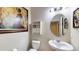 Half bathroom featuring tiled floors, pedestal sink, decorative mirror, and fixtures at 1723 Brassie Ct, Kissimmee, FL 34746
