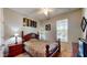 Comfortable bedroom with ceiling fan, side table and a large window providing natural light and outdoor views at 1723 Brassie Ct, Kissimmee, FL 34746
