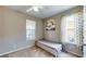 Cozy bedroom featuring a ceiling fan, carpet floors, and natural light from two windows at 1723 Brassie Ct, Kissimmee, FL 34746