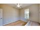 Simple bedroom offering a ceiling fan, neutral paint, and a window with blinds at 1723 Brassie Ct, Kissimmee, FL 34746
