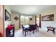 Airy dining room with chandelier and modern table, complemented by neutral walls and natural light at 1723 Brassie Ct, Kissimmee, FL 34746