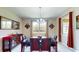 Formal dining room features a chandelier, large window, and elegant furniture at 1723 Brassie Ct, Kissimmee, FL 34746