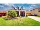 Charming home featuring a well-manicured front lawn and a screened porch at 1723 Brassie Ct, Kissimmee, FL 34746