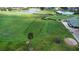 An aerial shot of a meticulously groomed golf course with players, a pond and lush green fairways at 1723 Brassie Ct, Kissimmee, FL 34746