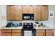 Updated kitchen with granite countertops, wooden cabinets, and stainless steel appliances at 1723 Brassie Ct, Kissimmee, FL 34746