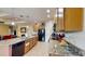 Charming kitchen featuring granite countertops, modern appliances, tile flooring, and ample cabinet space at 1723 Brassie Ct, Kissimmee, FL 34746