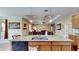 Open kitchen with island, dual sink, dishwasher, and view to the living area at 1723 Brassie Ct, Kissimmee, FL 34746