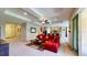 Open-concept living room with tray ceiling, carpet, and seamless flow into the kitchen area at 1723 Brassie Ct, Kissimmee, FL 34746