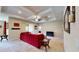Spacious living room with tray ceiling, fan, neutral carpet, and a stylish red couch at 1723 Brassie Ct, Kissimmee, FL 34746