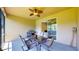 Comfortable screened-in patio with ceiling fan, outdoor dining, and cooking space at 1723 Brassie Ct, Kissimmee, FL 34746