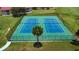 Two tennis courts in a fenced-in area with lush greenery, ideal for recreational sports at 1723 Brassie Ct, Kissimmee, FL 34746