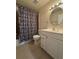 Bathroom featuring a zebra shower curtain, standard toilet, and single-sink vanity with ample lighting at 1844 Townhall Ln # 1844, Orlando, FL 32807