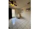 This tiled-floor bedroom features a ceiling fan and large sunny window at 1844 Townhall Ln # 1844, Orlando, FL 32807