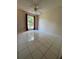 This bedroom features tiled flooring and a ceiling fan at 1844 Townhall Ln # 1844, Orlando, FL 32807
