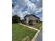 Well-maintained home exterior with lush green lawn and manicured landscaping at 1844 Townhall Ln # 1844, Orlando, FL 32807