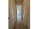 Hallway with tiled floor leading to a tiled-floor bedroom at 1844 Townhall Ln # 1844, Orlando, FL 32807