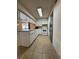Galley kitchen features modern appliances, plenty of counter space and cabinetry for storage, plus tile floors at 1844 Townhall Ln # 1844, Orlando, FL 32807