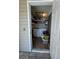 Practical laundry room with washer, dryer, and shelving for storage at 1844 Townhall Ln # 1844, Orlando, FL 32807