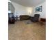 Comfortable living room with tile flooring, sofa, armchair, and natural light at 1844 Townhall Ln # 1844, Orlando, FL 32807