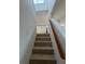 Tile staircase leads to an upper level, enhanced by a bright window and glass block accent wall at 1844 Townhall Ln # 1844, Orlando, FL 32807