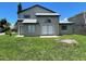 Spacious backyard with sliding glass doors, offering easy access to outdoor living and entertaining at 198 N Lake Ct, Kissimmee, FL 34743