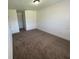 Neutral bedroom with a large window and neutral carpeting at 198 N Lake Ct, Kissimmee, FL 34743