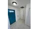 Bright foyer with white tile flooring, accented by a vibrant blue door at 198 N Lake Ct, Kissimmee, FL 34743
