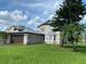 Charming two-story home with a well-manicured lawn and beautiful landscaping at 198 N Lake Ct, Kissimmee, FL 34743