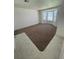 Open living room featuring a large bay window and neutral carpeting at 198 N Lake Ct, Kissimmee, FL 34743