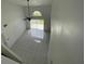 Bright living room features large windows, ceiling fan and tiled flooring at 198 N Lake Ct, Kissimmee, FL 34743