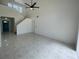 Bright living room with tile flooring, a ceiling fan, and views of the entryway at 198 N Lake Ct, Kissimmee, FL 34743