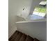 Bright living room view from stairs features large windows and tiled flooring at 198 N Lake Ct, Kissimmee, FL 34743