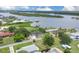 Breathtaking aerial view of waterfront home with lush greenery and stunning views of the serene bay at 203 Parkwood Ln, Edgewater, FL 32132