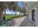 Stunning waterfront views from the property's backyard, adorned with lush greenery and mature palm trees at 203 Parkwood Ln, Edgewater, FL 32132