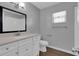 Neutral bathroom featuring a white vanity with countertop, toilet and gray walls at 203 Parkwood Ln, Edgewater, FL 32132