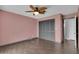 Bedroom with wood flooring and a ceiling fan provides a simple and comfortable living space at 203 Parkwood Ln, Edgewater, FL 32132