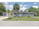 Charming single-story home with lush green lawn and mature palm trees enhancing its curb appeal at 203 Parkwood Ln, Edgewater, FL 32132