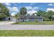 Charming single-story home showcasing a pristine lawn, landscaped garden beds, and inviting curb appeal at 203 Parkwood Ln, Edgewater, FL 32132