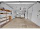 Spacious garage interior with ample storage, shelving, and convenient access to laundry facilities at 203 Parkwood Ln, Edgewater, FL 32132