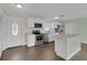 Stylish kitchen featuring stainless steel appliances, white cabinetry, and an island with a light green accent at 203 Parkwood Ln, Edgewater, FL 32132