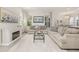 Open concept living room featuring neutral decor, fireplace, and large windows at 2057 Celebration Blvd, Celebration, FL 34747