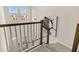 Carpeted staircase with white railings, dark trim, and natural light from the large windows above at 2057 Celebration Blvd, Celebration, FL 34747